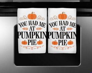 White kitchen towel with the phrase "You Had Me at Pumpkin Pie" and orange pumpkin graphics
