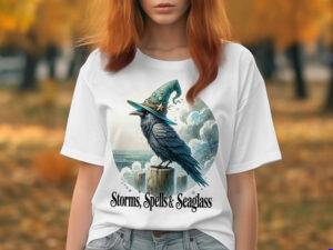 Mystical raven in a green witch hat sitting on dock posts by the ocean with storm clouds behind; text reads "Storms, Spells & Seaglass"