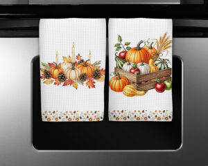 Two autumn kitchen towel sublimation PNGs featuring glowing pumpkin candles and a rustic crate of pumpkins, apples, and gourds with a coordinating border.