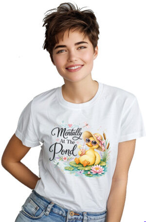 Mentally at the pond PNG featuring a watercolour duckling in a straw sun hat and pink sunglasses sipping an iced drink on a lily pad with water lilies, cattails, and dragonflies, shown on a white t-shirt.